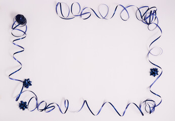 Frame from blue ribbon with gift bows on a white background with copy space.