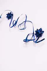 Blue ribbon decoration with gift bows. Shiny serpentine.