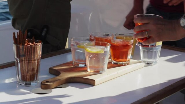 Crew on sailing yacht serving drinks after the sailing trip