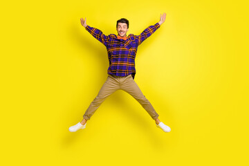 Fototapeta na wymiar Full body photo of young excited man happy positive smile have fun jump up isolated over yellow color background
