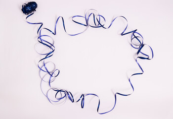 Blue shiny ribbon in a shape of circle. On a white background with a copy space.