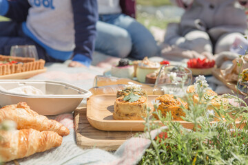 Picnic setting with picnic food, picnic hamper basket, guitar and food ready for party