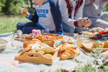Picnic setting with picnic food, picnic hamper basket, guitar and food ready for party