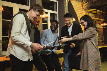 Colleagues working together in modern office using devices and gadgets during creative meeting