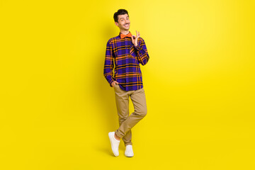 Fototapeta na wymiar Full length photo of young handsome man happy positive smile fix bowtie date event cool isolated over yellow color background