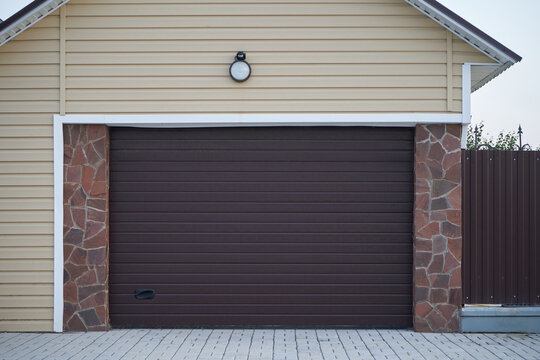 Automatic lifting garage door brown of a modern garage.