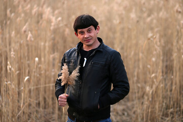 Portrait of a brunette man in the park