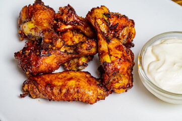 Fresh fried chicken on a white plate set on a wood table