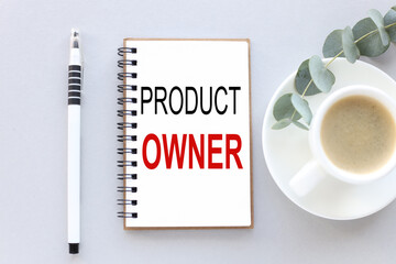 Product Owner, text on white notepad paper. near cups with coffee and plants on a gray background.