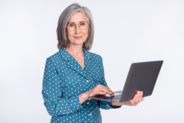 Photo portrait of senior business woman smiling using computer isolated on white color background