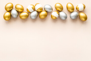 Flat lay of golden and silver eggs. Good luck symbol. Easter decoration