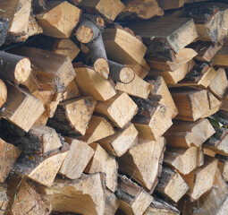 The wood for the stove is neatly stacked. Firewood for heating a private house in winter