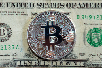 bitcoin coin on a dollar