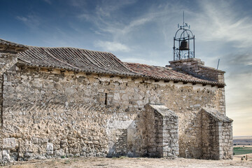 Fototapeta na wymiar Pared, campana y veleta ermita de nuestra señora del castillo en Trigueros del Valle, Castilla y León