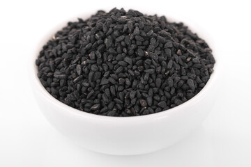 Black cumin seeds. Black cumin in white bowl on white background. nigella sativa, black sesame, black cumin,