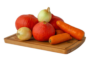Autumn vegetables pumpkins, carrots, onions on wood cut board isolated white
