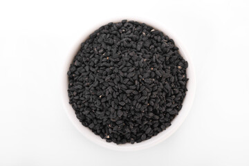 Black cumin seeds. Black cumin in white bowl on white background. nigella sativa, black sesame, black cumin,