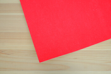 Red paper and wood background. Texture. Background