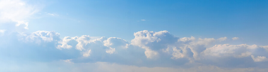 Blue and white clouds in the sky in bright sunlight