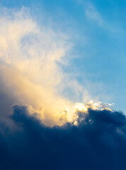 Light and dark clouds in the dramatic sky during sunset