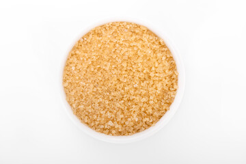 brown sugar. Granulated brown sugar in white bowl on white background.