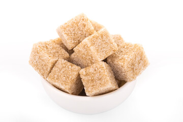 brown sugar cubes. brown sugar in white bowl on white background. sugar cubes, cane sugar