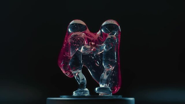 Pink slime covers the glass figurine in the form of a couple.