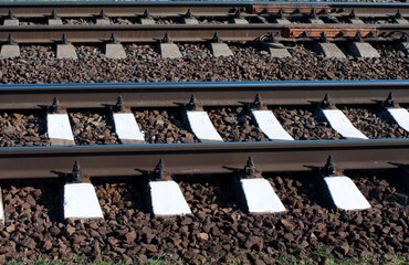 Railway with rails and sleepers parallel. Gray and white stripes