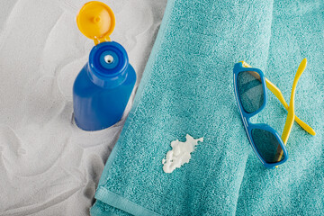 Cosmetic stain sunscreen lotion spilling on a turquoise towel. Daily life dirty stain for wash and...