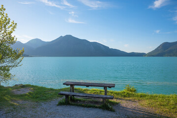 bench at lake shore Walchensee, view to Herzogstand mountain