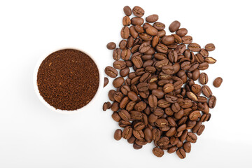 ground coffee. ground coffee in white bowl on white background with coffee beans.
