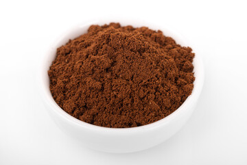 turkish coffee. ground turkish coffee in white bowl on white background.
