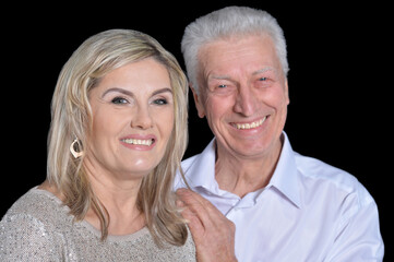 happy Senior couple posing on black background