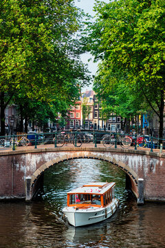 Amsterdam view - canal with boad, bridge and old houses