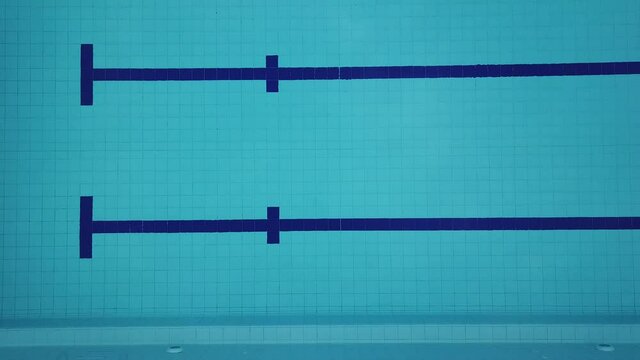 An overhead shot of an empty blue Olympic pool in 4K