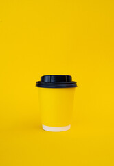 yellow coffee cup on yellow background