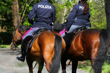 Pair of policemen on horseback patrolling the Villa Borghese in Rome