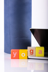 yoga mat with laptop computer ready for an online class or classes with lettering yoga