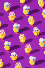 Minimal Easter pattern background with party chicken with hat, tie and glasses. Creative party or holiday concept.
