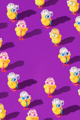 Minimal Easter pattern background with party chicken with hat, tie and glasses. Creative party or holiday concept. Copy space.