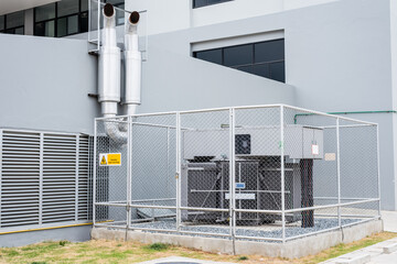 Large power transformers are installed outside the building and gated around. In converting AC...