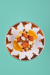 Vegetarian toast with scrambled eggs, pumpkin, nuts and brie. Lenten dish on a colored background. Top view. Mockup. Space for text