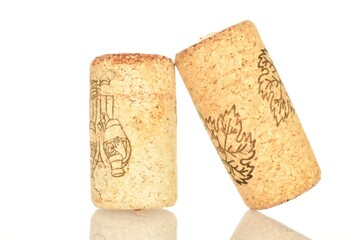 Two wine corks, close-up, on a white background.