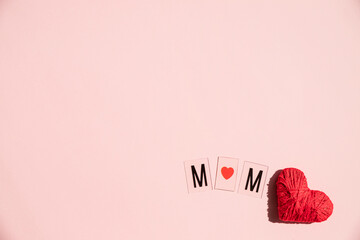 Phrase I LOVE MUM made of letters on pink background. Happy Mother's Day.greeting card .Creative Composition with red heart and envelope. Love and family concept.Copy space