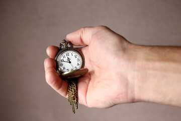 a pocket watch in the hands of a man