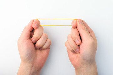 Yellow rubber band on a white background
