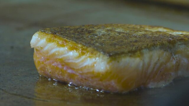a delicious salmon roasting on a stove