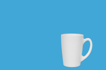 White cup for coffee on a blue background.