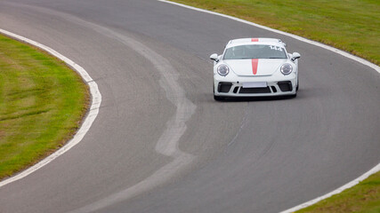 A shot of a racing car as it circuits a track.