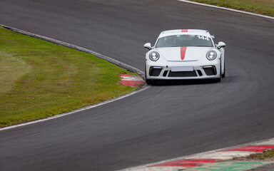 A shot of a racing car as it circuits a track.
